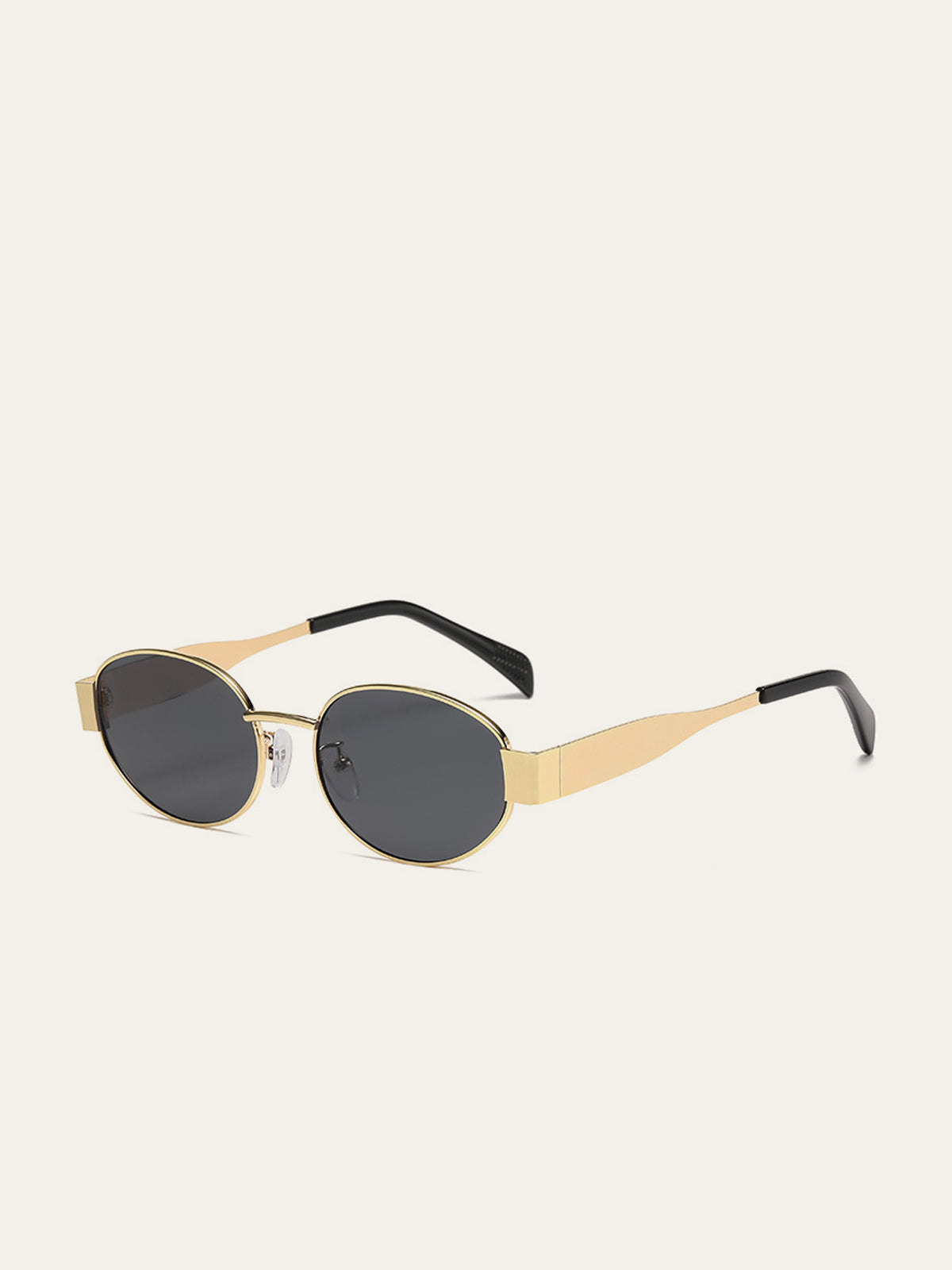 Elegante ovale zonnebril met gouden accenten